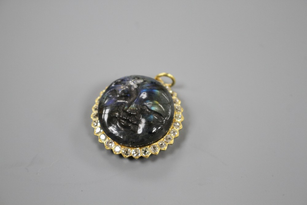A 20th century yellow metal, diamond and carved labradorite? moon face pendant, 26mm, gross weight 7.2 grams.